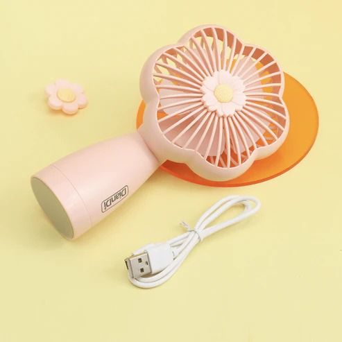 Compact flower fan held in a hand