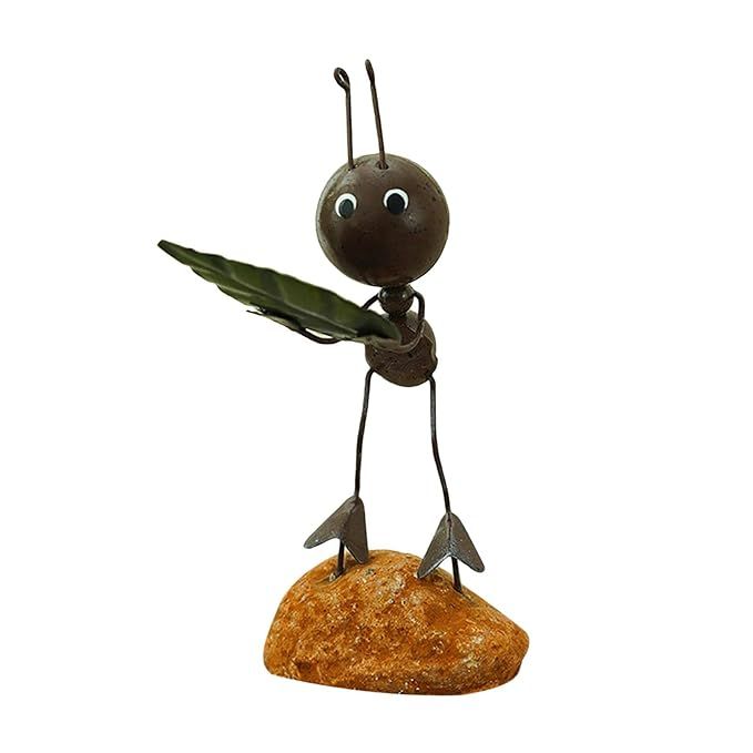 Metal ant ornament displayed on a desk
