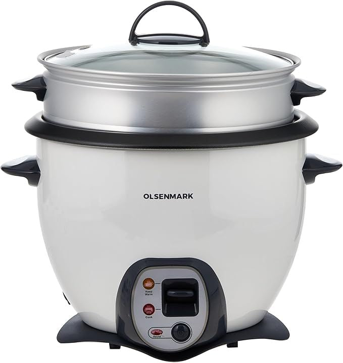 Rice cooking with vegetables steaming above